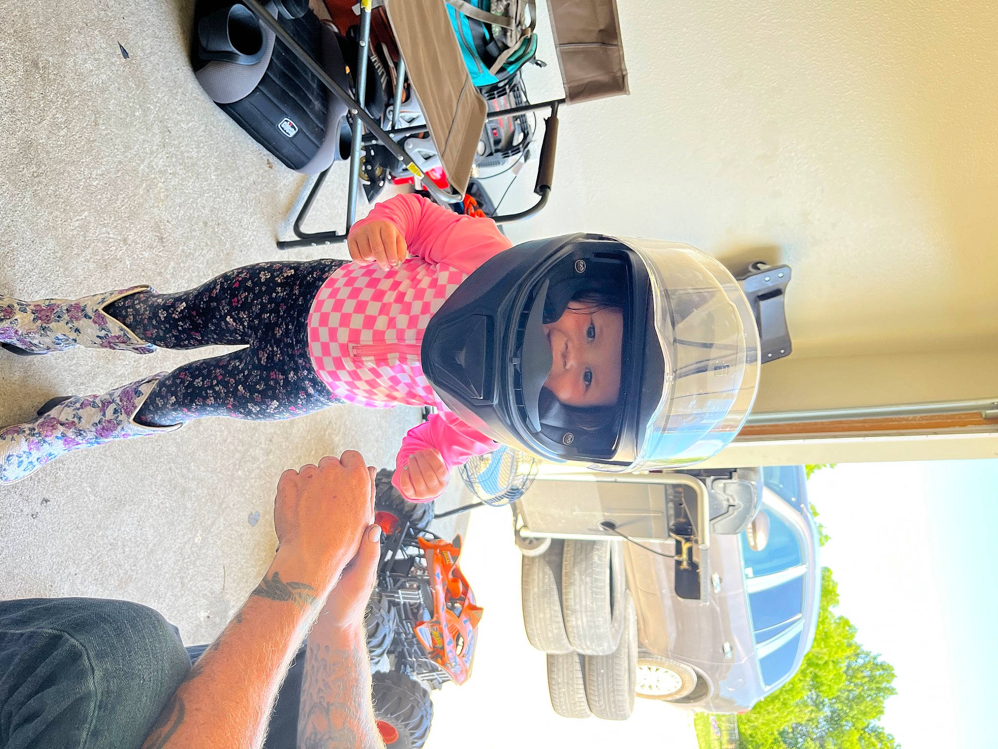 Pearl is registered to the contest to win money with this photo: arm, automotive_design, automotive_exterior, automotive_tire, car, electric_blue, eyewear, fun, hat, headwear, human_leg, machine, motor_vehicle, person, sky, thigh, tire, tree, vehicle, vehicle_door