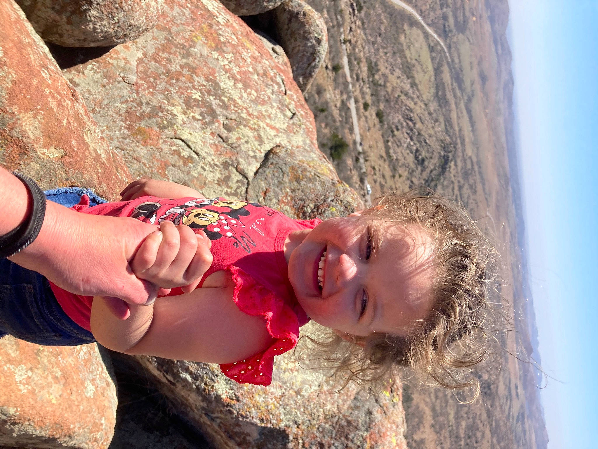 Hope is registered to the contest to win money with this photo: adventure, arm, bedrock, child, dress, fun, happy, jewellery, joy, landscape, leisure, outcrop, people_in_nature, person, recreation, rock, sky, smile, sport_climbing, thigh