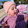 baby, cheeks, child, cute, earring, hand, happy, nature, outdoor, park, pink_beanie, pink_jacket, portrait, shadow, smile, stroller, sunlight, toddler, trees, weekend