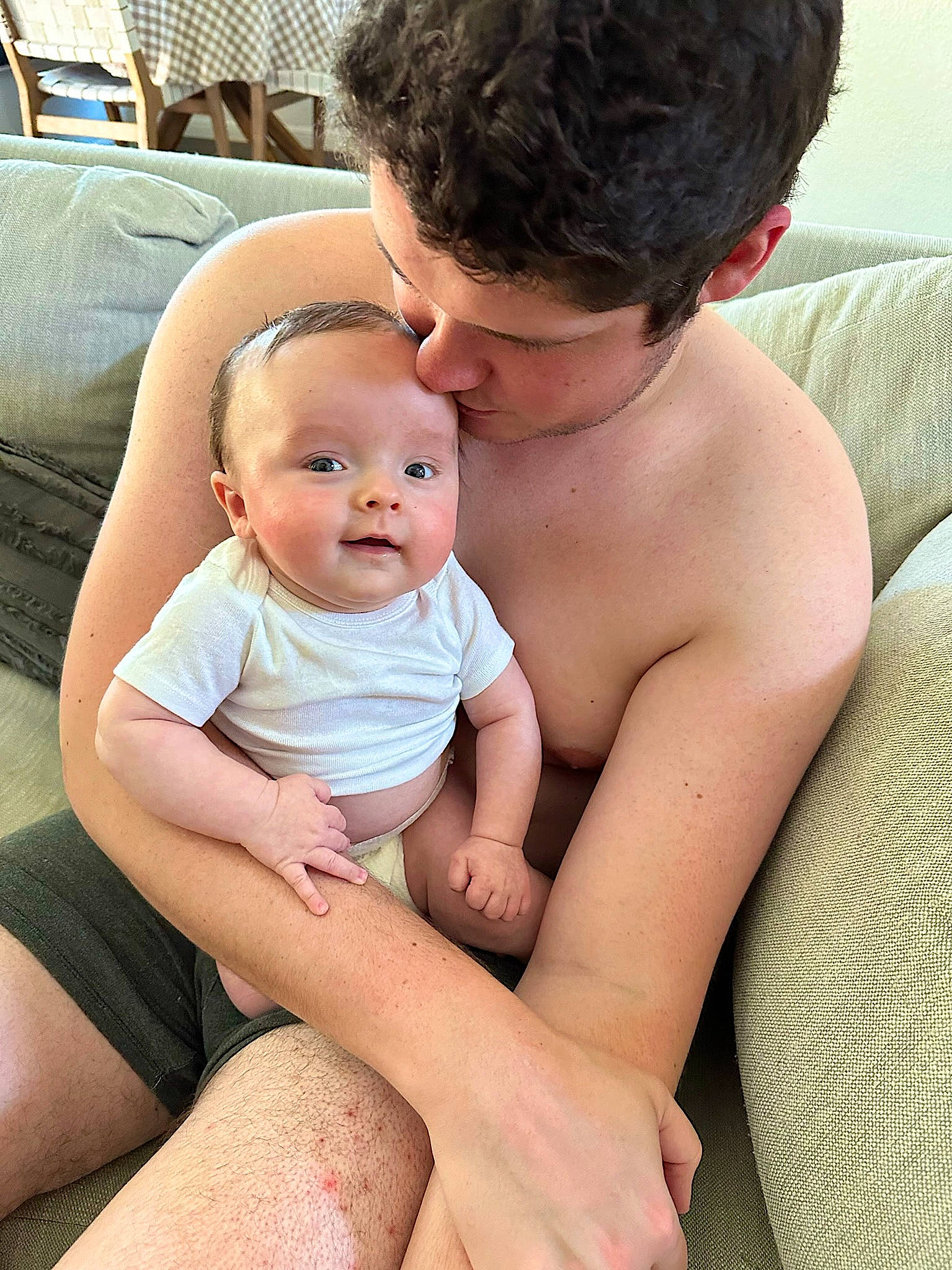 Tripp is registered to the contest to win money with this photo: baby, cheek, comfort, eye, face, finger, gesture, hair, happy, head, human_body, interaction, joint, leg, muscle, neck, person, shoulder, skin, stomach