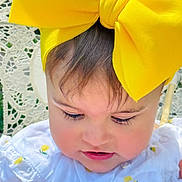 Mis Bas joined the competition — help win amazing prizes! adorable, baby, child, close_up, cute, expression, face, headwear, infant, lace_background, looking_down, outdoor, patterned_clothing, person, portrait, skin, soft_light, white_clothing, yellow_bow, young_child