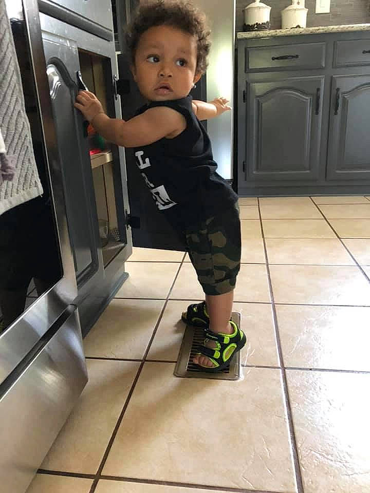 Jakobe is registered to the contest to win money with this photo: arm, child, floor, flooring, footwear, human_leg, joint, knee, leg, person, shoe, shoulder, sportswear, standing, surprise, toddler, vacation