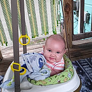 Wilder is registered to the contest to win money with this photo: baby, infant, swing, blanket, smile, cheeks, porch, wood, pattern, clothing, seat, happy, child, cute, outdoor, fabric, toy, person, comfort, playtime