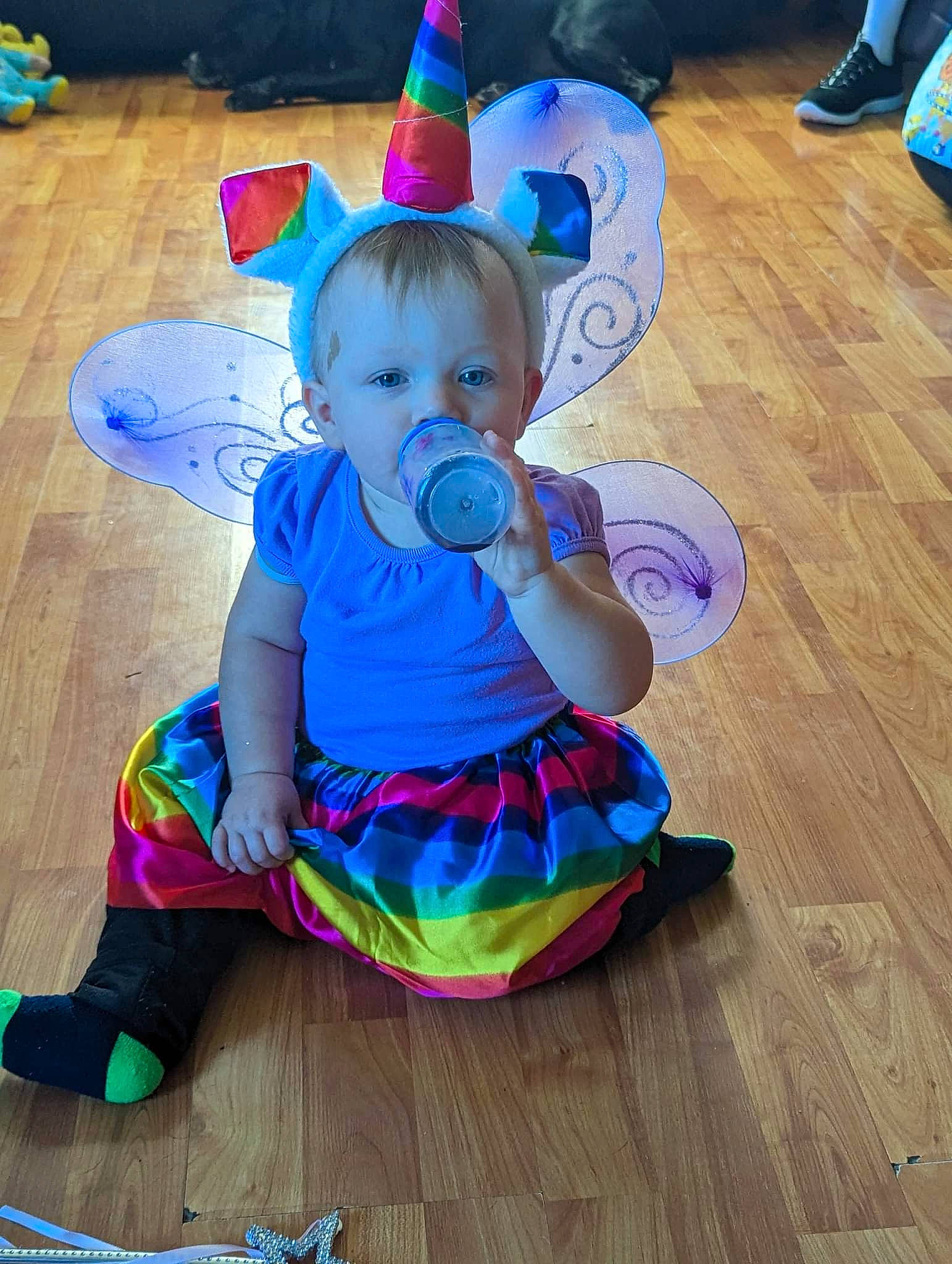 Davina is registered to the contest to win money with this photo: baby, baby_toddler_clothing, blue, costume_hat, electric_blue, event, floor, flooring, fun, happy, hardwood, party_hat, person, pink, purple, sitting, toddler, varnish, wood, wood_flooring