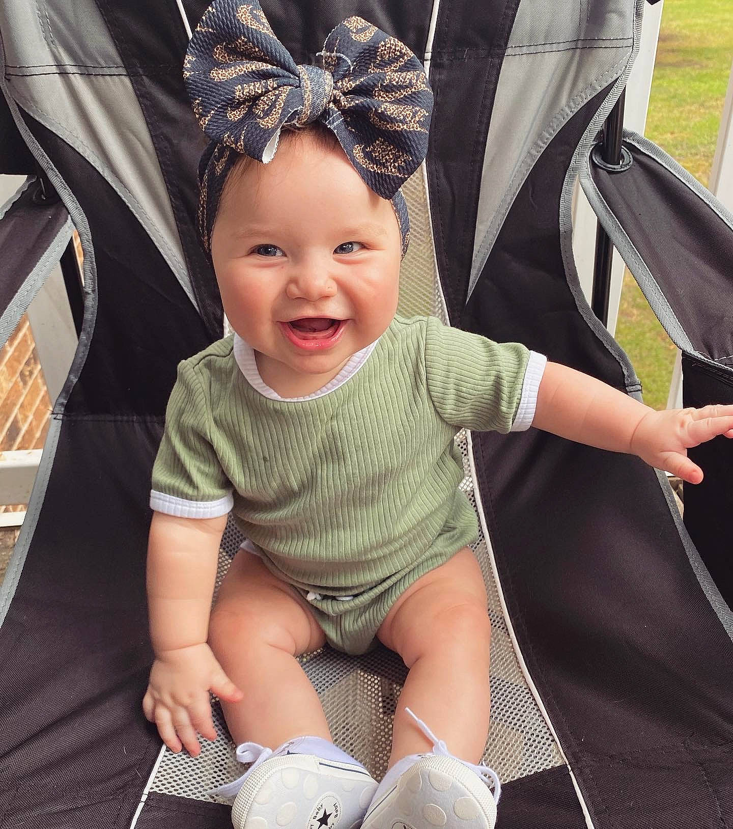 Aspyn is registered to the contest to win money with this photo: baby, baby_carriage, baby_products, baby_toddler_clothing, black, child, fun, gesture, happy, head, headgear, headwear, lap, person, photograph, skin, smile, snapshot, thigh, thumb