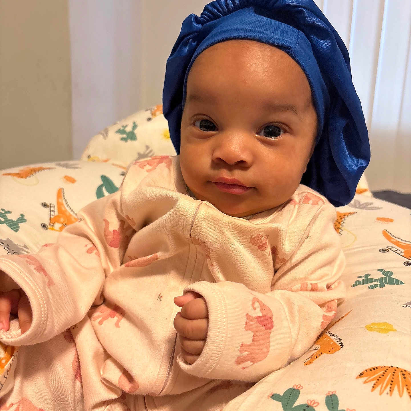 Melsandra joined the competition — help win amazing prizes! baby, baby_bed, blue_bonnet, cactus_pattern, child, clothing, cozy, cushion, cute, dinosaur_pattern, elephant_print, face, hand, indoor, infant, person, pink_onesie, portrait, relaxing, soft_light