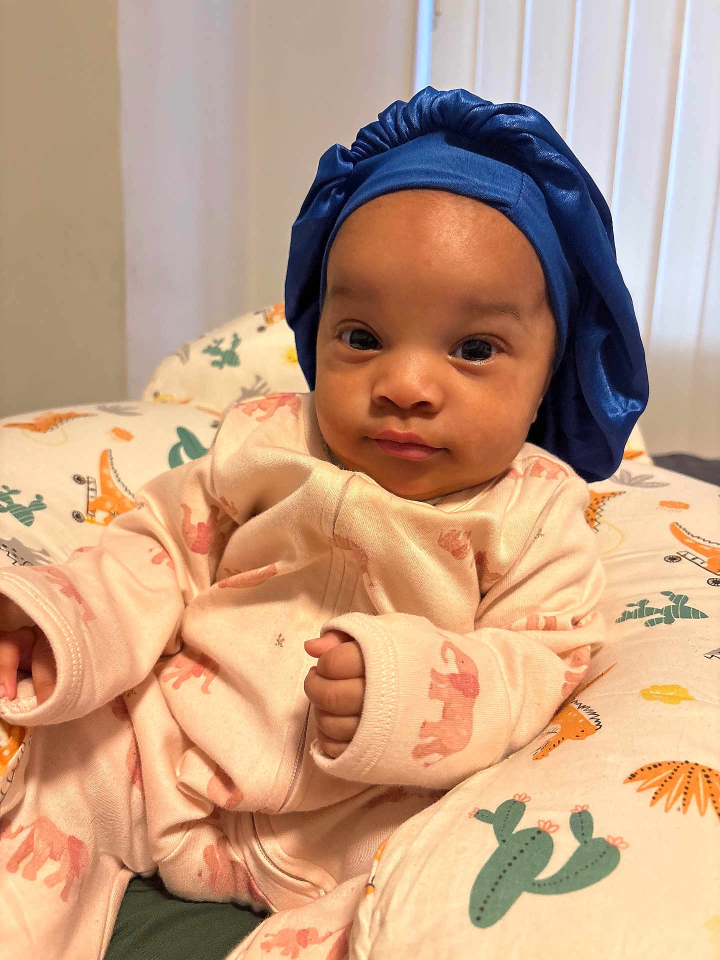 Melsandra joined the competition — help win amazing prizes! baby, baby_bed, blue_bonnet, cactus_pattern, child, clothing, cozy, cushion, cute, dinosaur_pattern, elephant_print, face, hand, indoor, infant, person, pink_onesie, portrait, relaxing, soft_light