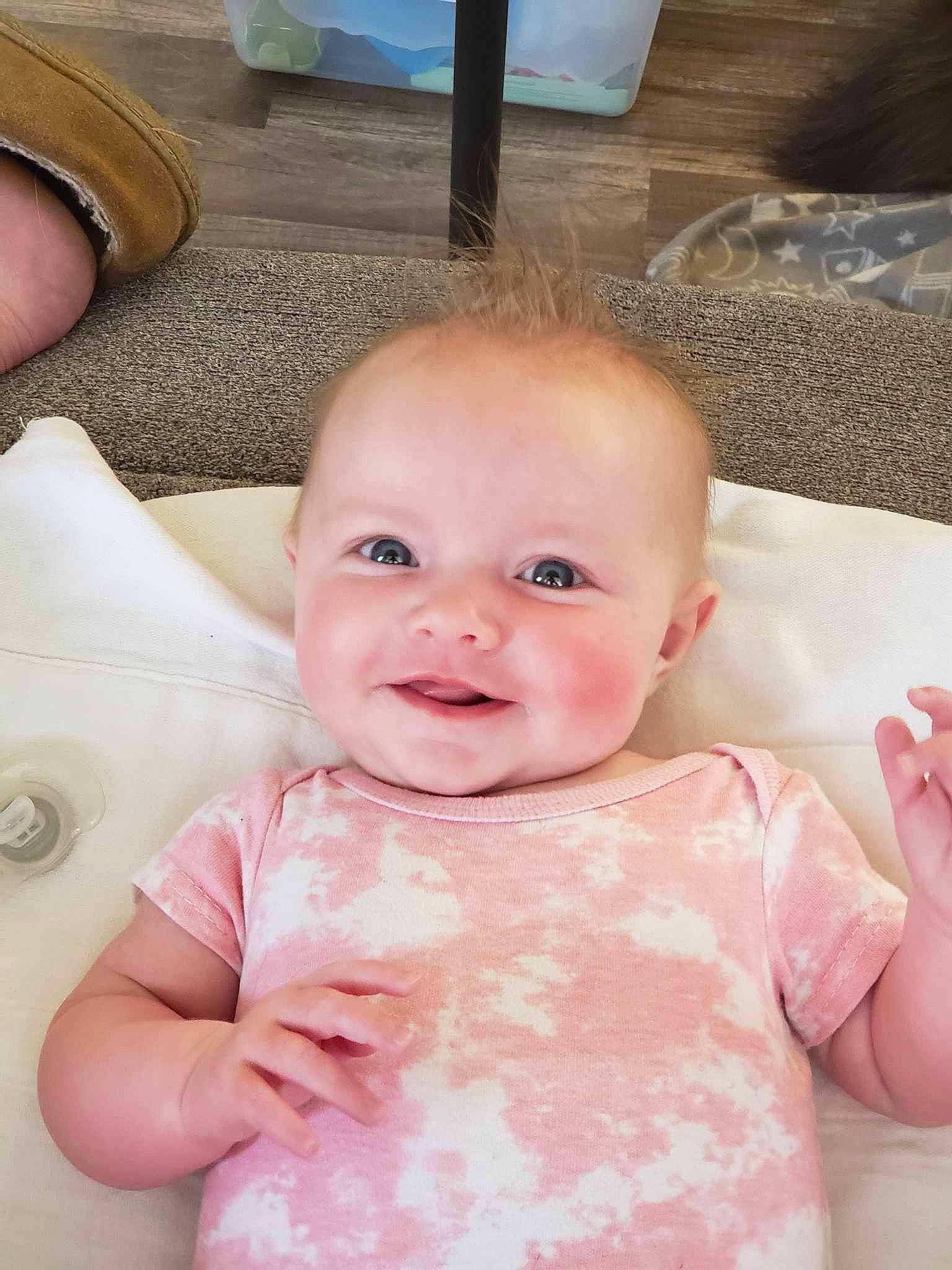 Astrid joined the competition — help win amazing prizes! baby, baby_toddler_clothing, cheek, chin, facial_expression, finger, gesture, hand, happy, iris, joy, lip, mouth, musical_instrument, person, pink, skin, sleeve, smile, standing