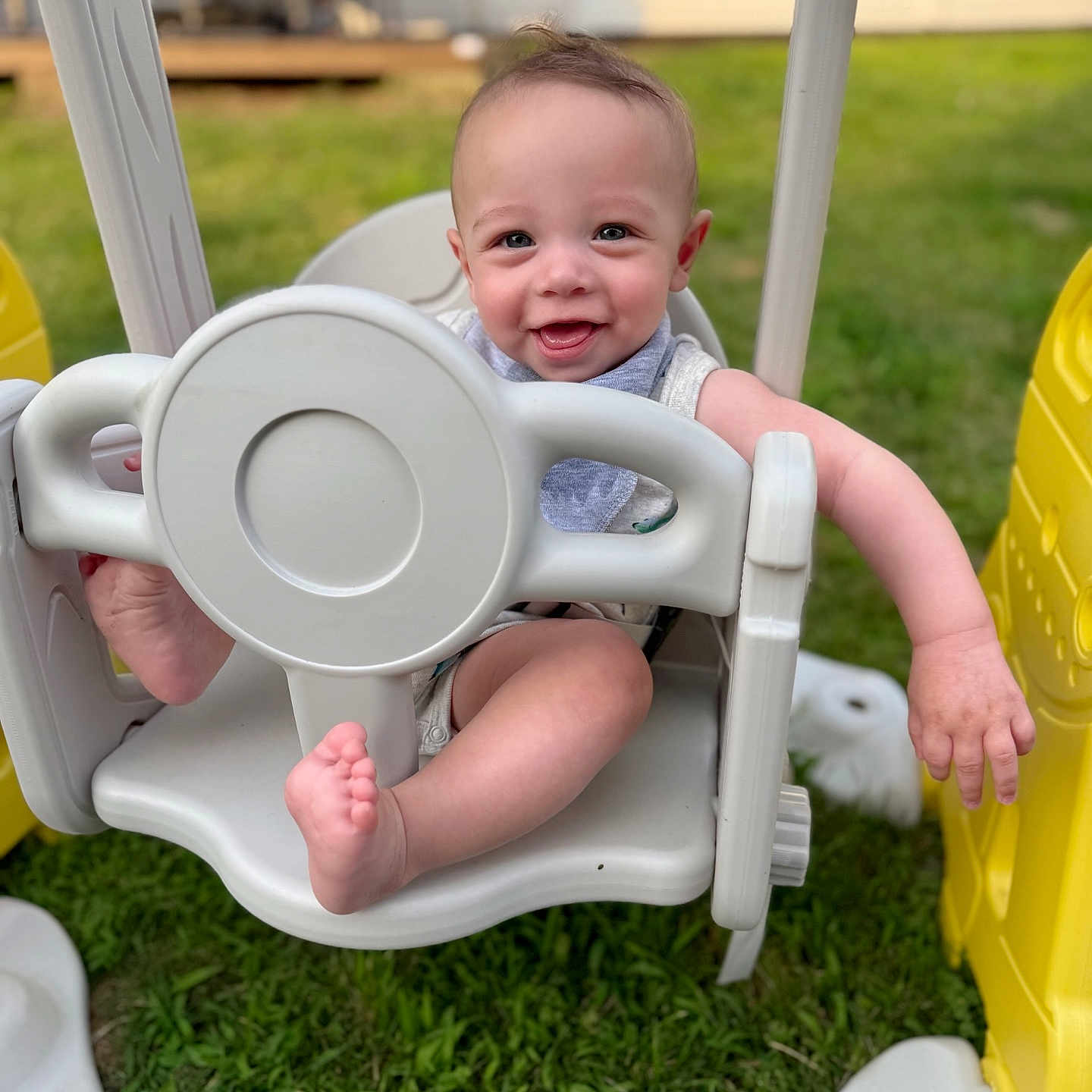 Oliver joined the competition — help win amazing prizes! baby, child, cute, daylight, feet, fun, grass, hand, happy, infant, nature, outdoor, plastic, play, playground, seat, smiling, summer, swing, toy