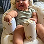 Liam is registered to the contest to win money with this photo: baby, infant, smiling, happy, inflatable_chair, teddy_bear_pattern, cute, child, indoors, floor, foot, arm, clothing, toy, furniture, person, portrait, chubby, sitting, home