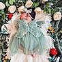 baby, infant, fairy_wings, green_dress, headband, blanket, flowers, roses, leaves, toys, ladybug, butterfly, soft_texture, sleeping, cute, decor, nature_theme, laying_down, white_blanket, peaceful