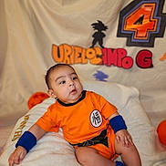 Bodoquito joined the competition — help win amazing prizes! baby, backdrop, birthday_decoration, blanket, blue_socks, blue_wristband, child, cute, decorative_letters, dragon_ball, gaze, goku_silhouette, infant, number_4, orange_outfit, plush, portrait, sitting, studio_lighting, watermark