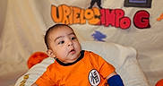 Bodoquito joined the competition — help win amazing prizes! baby, backdrop, birthday_decoration, blanket, blue_socks, blue_wristband, child, cute, decorative_letters, dragon_ball, gaze, goku_silhouette, infant, number_4, orange_outfit, plush, portrait, sitting, studio_lighting, watermark