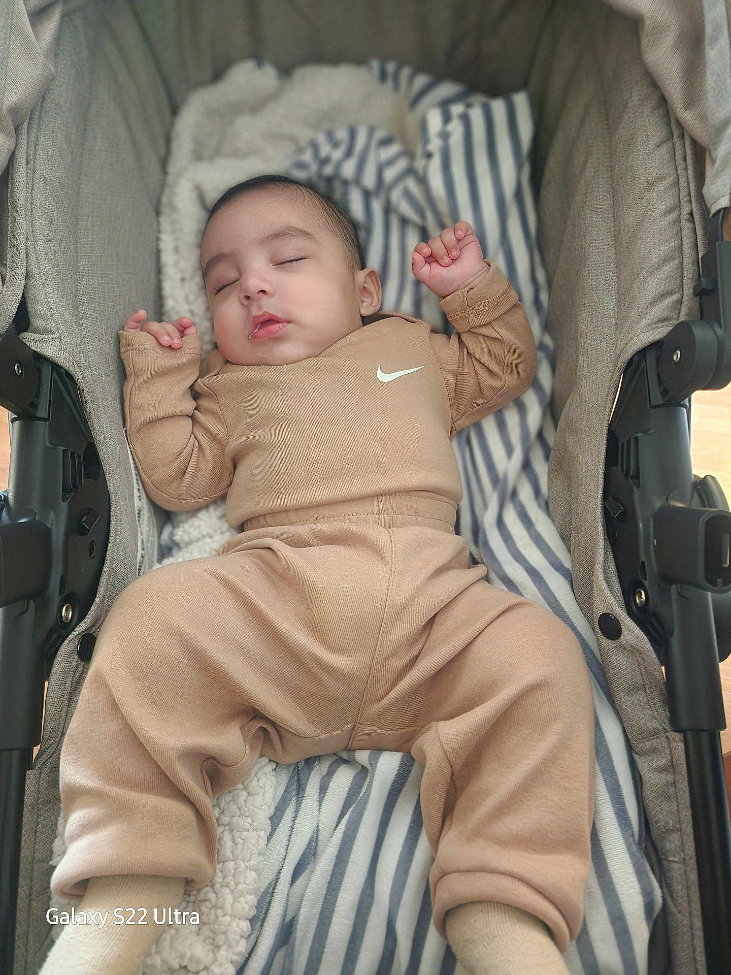 Bodoquito joined the competition — help win amazing prizes! baby, infant, newborn, sleeping, stroller, blanket, striped_blanket, cozy, tan_outfit, nike_logo, drooling, peaceful, portrait, cute, pajamas, head, hands, legs, soft_fabric, indoor