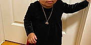 Willa-Jah joined the competition — help win amazing prizes! toddler, child, black_bow, curly_hair, black_top, velvet, necklace, red_checkered_leggings, black_sneakers, wooden_floor, door, indoors, standing, young_child, fashion, cute, portrait, person, floor, hand_on_door