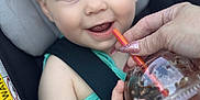 Aubri joined the competition — help win amazing prizes! baby, child, car_seat, headband, pink, blue_eyes, smiling, drink, straw, hand, nail_polish, green_clothing, seatbelt, infant, closeup, happy, person, portrait, cute, indoor