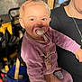 adult, bucket, casual, child, cute, family, happy, holding, indoor, pacifier, person, playful, pony_tail, portrait, purple_clothing, smiling, sneakers, toddler, tools, young_child