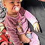 Aubri joined the competition — help win amazing prizes! accessory, adult_hand, apparel, baby, child, closeup, clothing, cute, face, footwear, holding, indoor, pacifier, person, pink, pony_tail, purple_clothing, smiling, sneakers, young_child