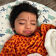 Vyom joined the competition — help win amazing prizes! baby, blanket, child, closed_eyes, cushion, cute, elephant_print, face_mark, floor, hand, indoor, orange_clothing, patterned_clothing, peaceful, portrait, resting, sleeping, soft_lighting, toddler, wood_floor