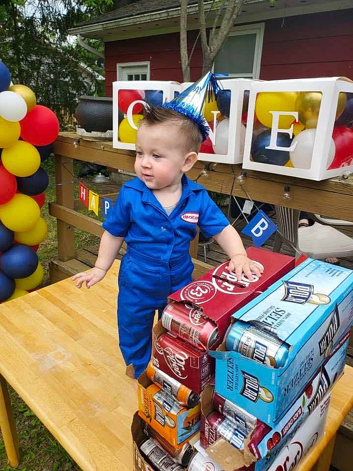 Henri joined the competition — help win amazing prizes! automotive_exterior, baby, balloon, box, carton, child, event, fun, leisure, packaging_and_labeling, party_supply, person, play, retail, shelf, shipping_box, sitting, t_shirt, tire, toddler