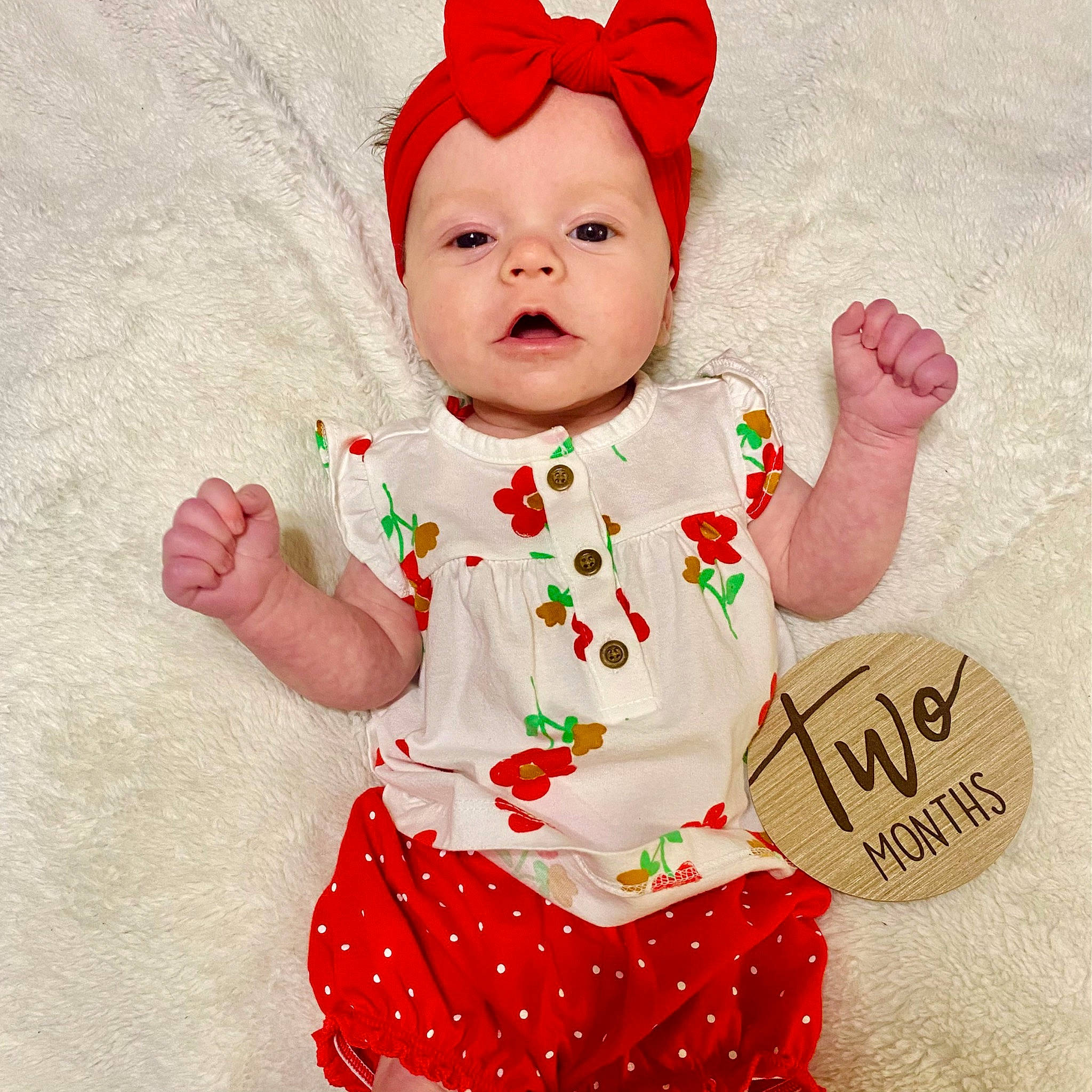 Aubree is registered to the contest to win money with this photo: arm, baby, baby_toddler_clothing, cap, carmine, child, costume_hat, event, face, facial_expression, finger, happy, hat, headwear, pattern, person, pink, pleased, red, sleeve