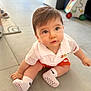 éli a rejoint le concours — aidez-le/la à gagner de superbes lots ! baby, child, indoor, sitting, floor, white_polo, orange_shorts, white_socks, nike_logo, blue_eyes, curious, soft_hair, tile_floor, person, young_child, cute, indoor_lighting, portrait, candid, playful