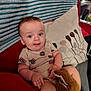 baby, blanket, child, clothing, comfort, couch, cozy, cute, furniture, home, indoor, infant, person, pillow, plush_toy, portrait, relaxing, seated, smiling, soft_toy
