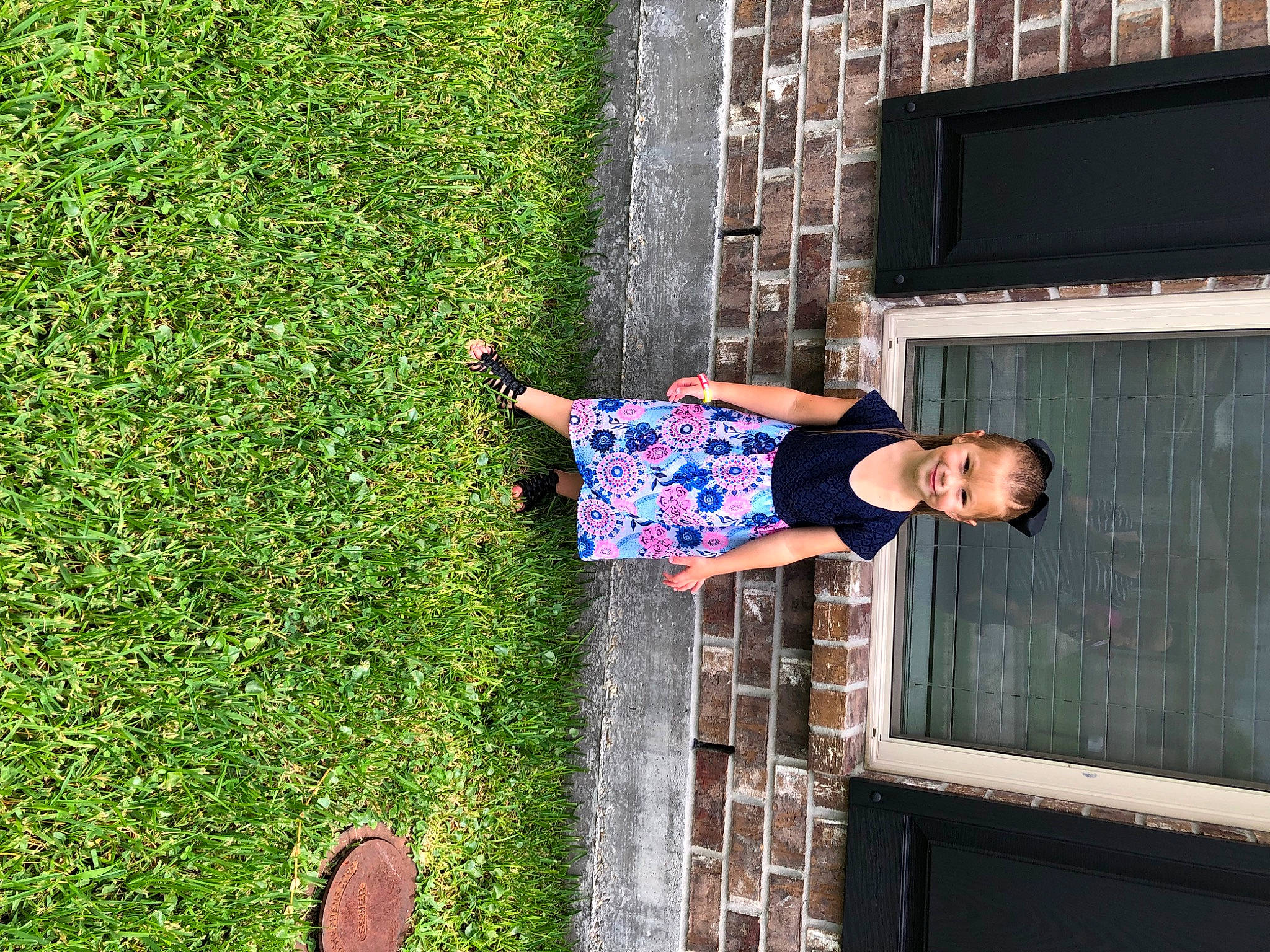 Anastasia joined the competition — help win amazing prizes! brick, brickwork, child, electric_blue, foot, fun, grass, happy, house, human_leg, joy, leisure, people_in_nature, person, plant, sandal, shrub, sitting, t_shirt, television