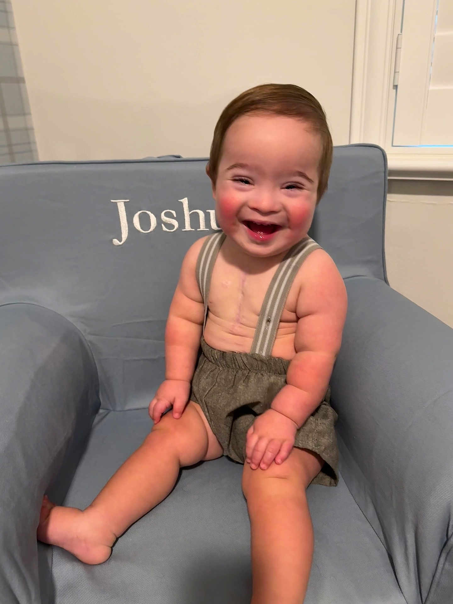 Joshua joined the competition — help win amazing prizes! toddler, child, smiling, happy, sitting, armchair, clothing, suspenders, shorts, face, person, indoor, furniture, baby, cute, rosy_cheeks, hair, window, home, portrait
