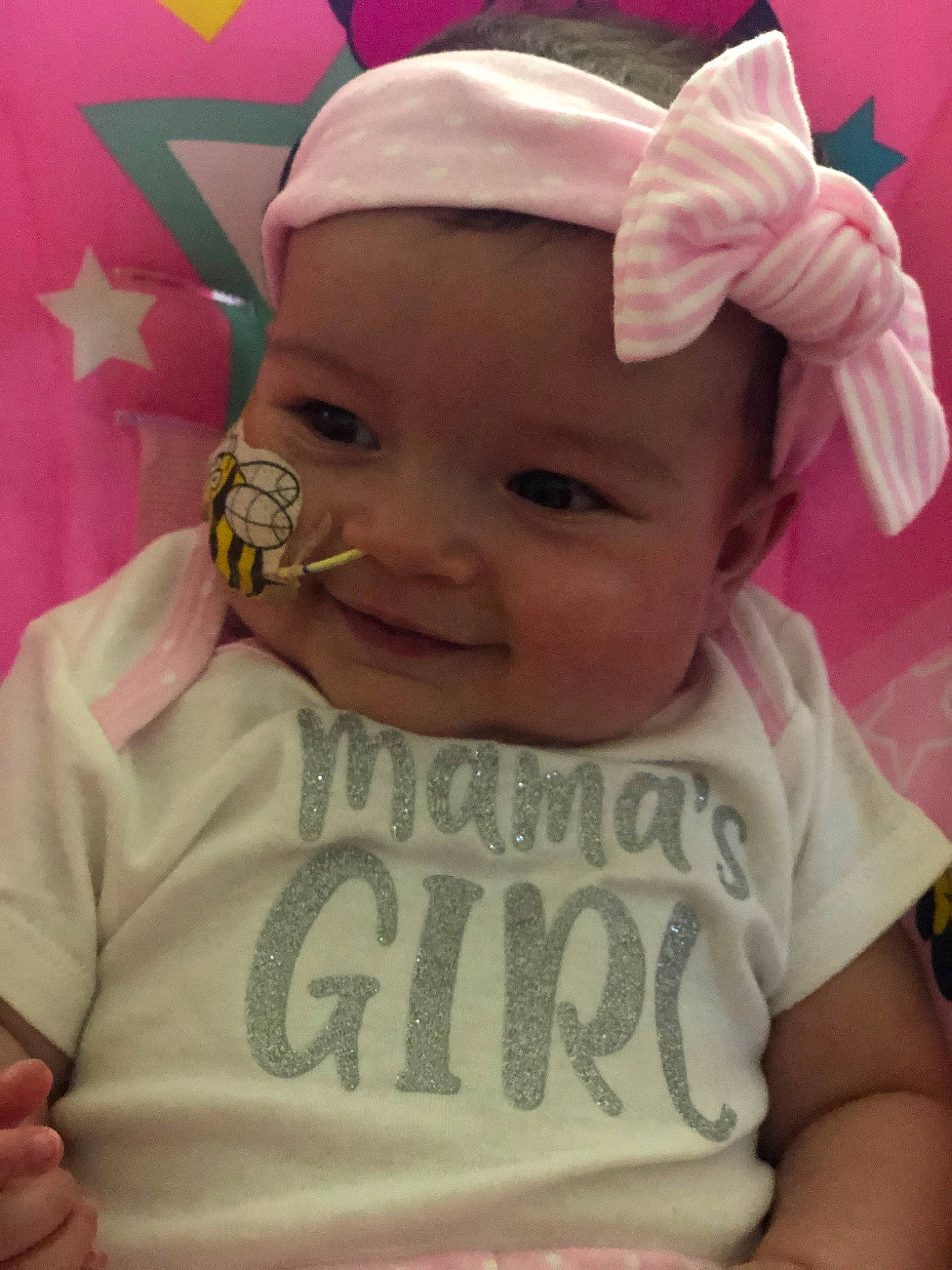 Hermione is registered to the contest to win money with this photo: baby, baby_toddler_clothing, cheek, child, ear, face, forehead, hair_accessory, head, headgear, headwear, person, pink, skin, toddler