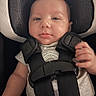 baby, infant, car_seat, child, seatbelt, straps, headrest, clothing, person, portrait, indoor, safety, cute, smile, young, skin, face, hand, comfort, babywear