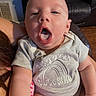 Leo joined the competition — help win amazing prizes! baby, infant, child, onesie, clothing, person, indoor, couch, leather, furniture, hand, arm, face, mouth_open, expression, head, skin, human, sitting, holding