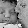 Lou participe au concours pour gagner de l'argent avec cette photo : baby, adult, face, close_up, black_and_white, sleeping, kiss, affection, love, skin, texture, portrait, intimate, tender, peaceful, cuddle, person, infant, emotion, parent