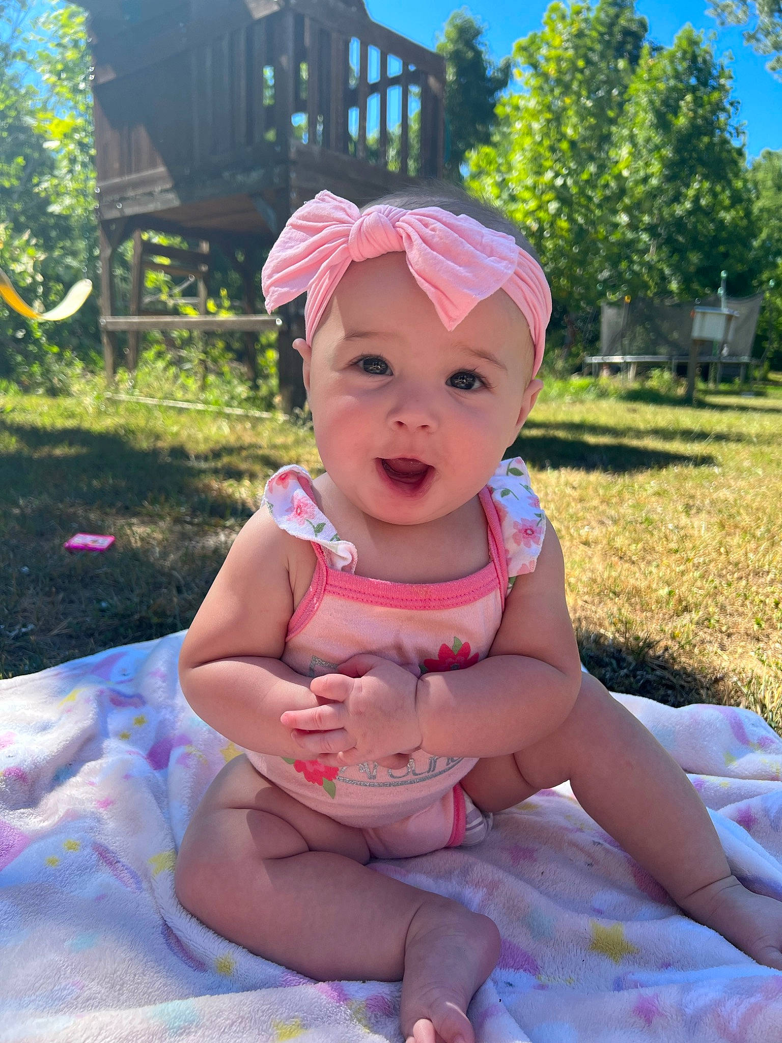 Sunni joined the competition — help win amazing prizes! baby, baby_toddler_clothing, cap, child, fashion_accessory, fun, grass, happy, hat, headwear, leisure, person, pink, plant, recreation, sitting, sky, smile, summer, sun_hat