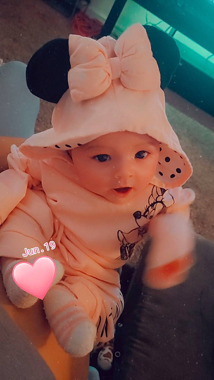 Isabella is registered to the contest to win money with this photo: art, baby, baby_products, baby_toddler_clothing, cap, cheek, child, costume, costume_accessory, costume_hat, fashion_accessory, happy, hat, headwear, party_supply, pattern, peach, person, pink, sitting