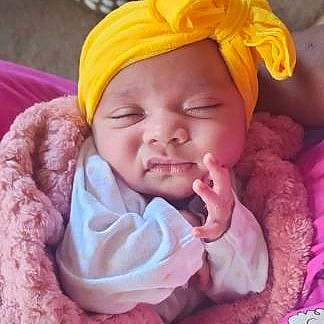 Aliza is registered to the contest to win money with this photo: baby, cap, cheek, chin, comfort, eye, happy, headwear, knit_cap, lip, magenta, mouth, nose, person, pink, purple, skin, smile, textile, thumb