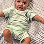 baby, infant, child, smiling, lying_down, mickey_mouse, clothing, blanket, texture, cute, happy, skin, face, head, legs, arms, one_person, indoor, soft, playful