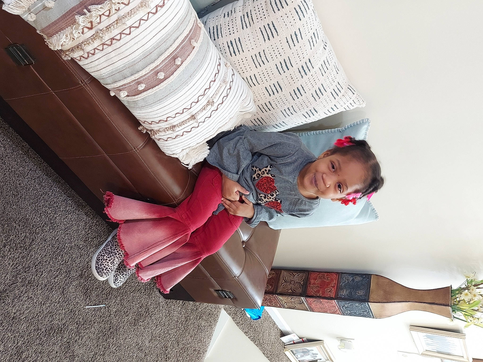 Rayiahlyn is registered to the contest to win money with this photo: book, carmine, comfort, costume, flooring, fun, human_leg, joy, knee, leg, paper, pattern, person, publication, room, sandal, shoe, sitting, sock, thigh