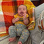 Papalovy joined the competition — help win amazing prizes! baby, infant, clothing, yellow_shirt, gray_pants, blanket, plaid, orange, yellow, bed, cushion, smiling, happy, person, feet, hands, head, indoors, furniture, cute