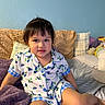Angelina joined the competition — help win amazing prizes! toddler, child, pajamas, blueberry_pattern, bed, pillow, blanket, indoor, smile, face, person, young_child, cozy, room, home, casual, seated, cute, comfort, relaxed