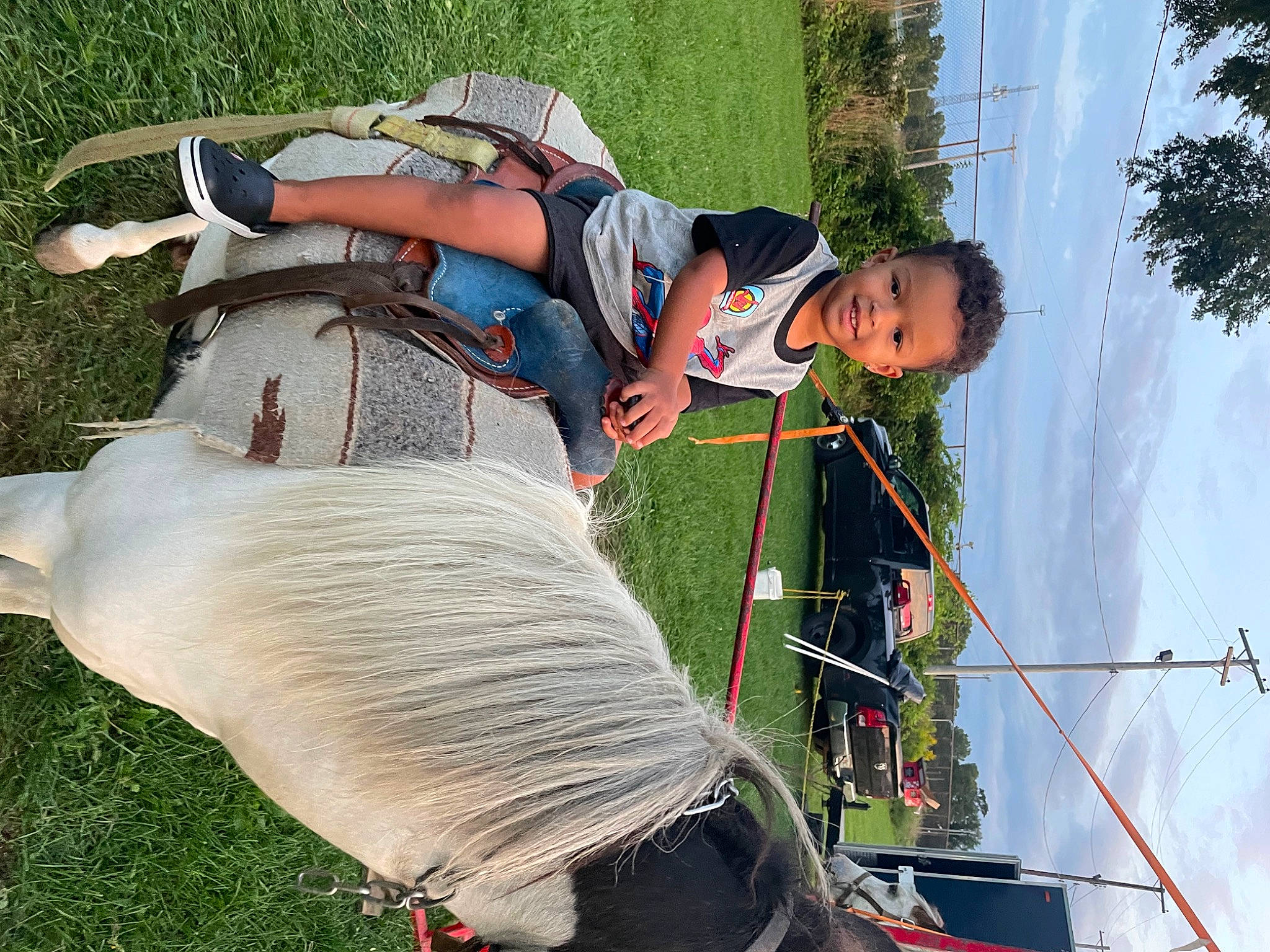 Delvonte Jr is registered to the contest to win money with this photo: adventure, boats_and_boating_equipment_and_supplies, fun, grass, green, joy, leisure, luggage_and_bags, person, personal_protective_equipment, plant, recreation, rope, sky, sport_climbing, tree, water_transportation, white