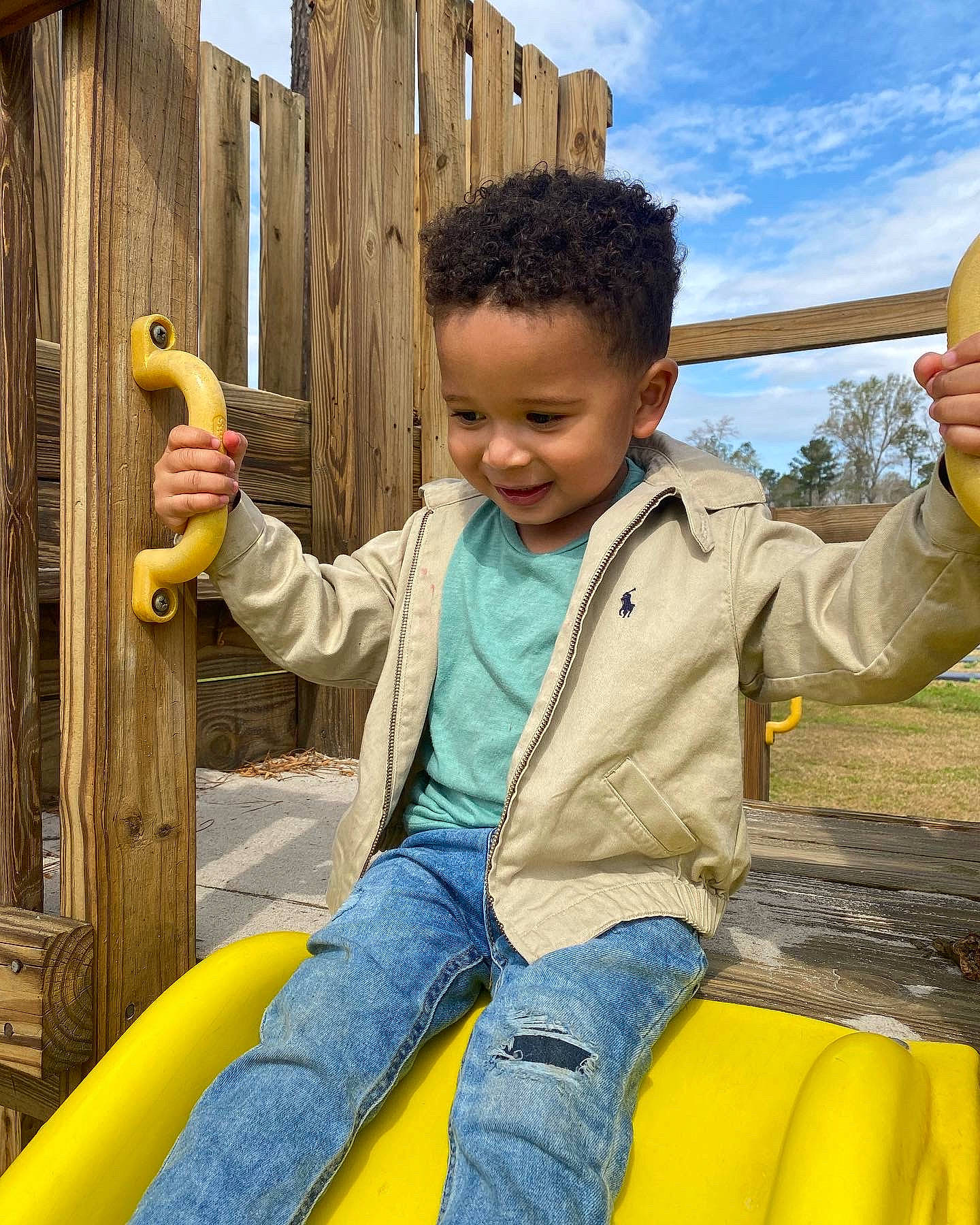 Ashton is registered to the contest to win money with this photo: cloud, eye, finger, fun, hand, happy, head, jeans, joy, leisure, person, photograph, sky, smile, snapshot, standing, thumb, toddler, toy, travel