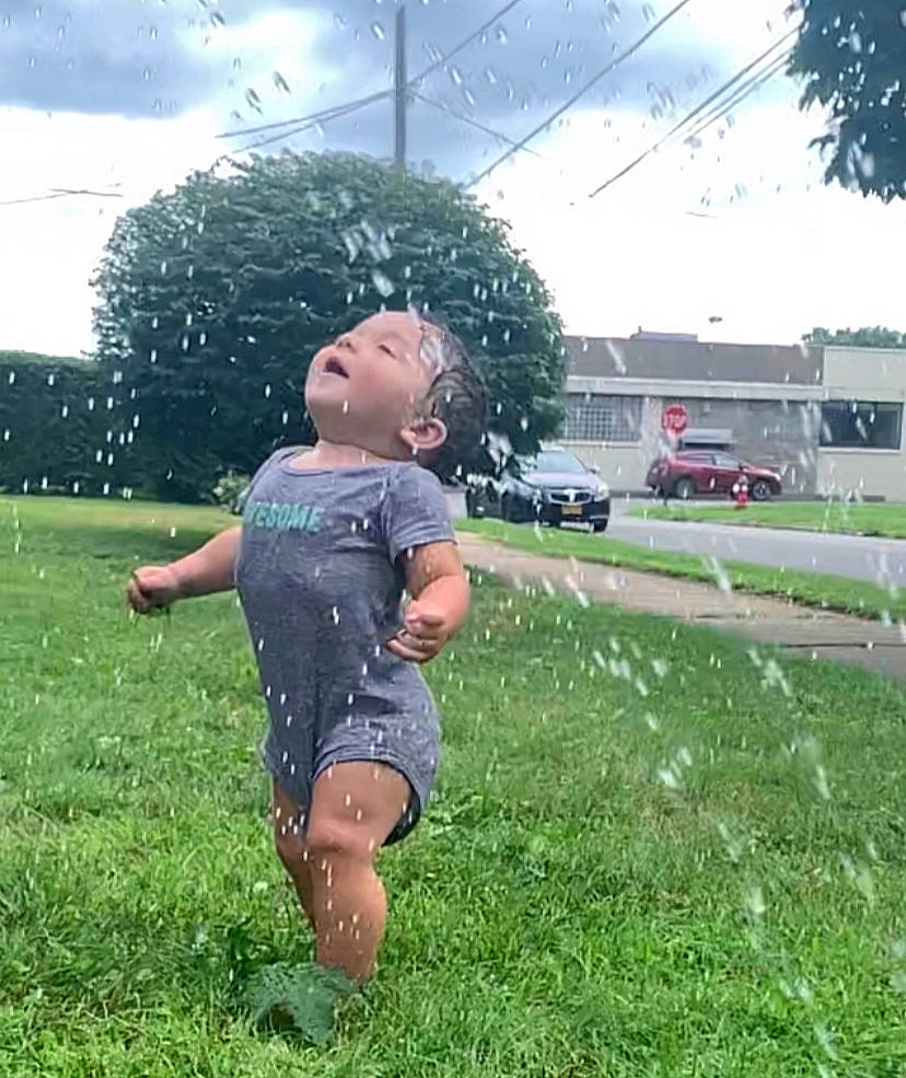 Angelo is registered to the contest to win money with this photo: car, cloud, grass, grass_family, grassland, happy, headwear, landscape, lawn, leisure, meadow, morning, people_in_nature, person, plant, recreation, shorts, sky, t_shirt, tire