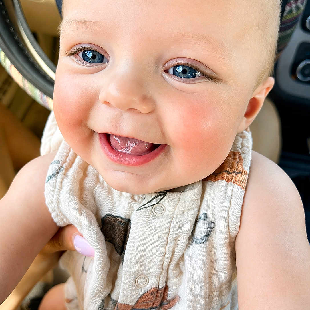 Holden joined the competition — help win amazing prizes! baby, smiling, close_up, blue_eyes, cute, child, infant, happy, portrait, face, skin, clothing, hand, expression, person, cute_baby, indoors, seat, car_interior, buttoned_shirt