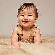Enzo joined the competition — help win amazing prizes! baby, smiling, happy, infant, overalls, cute, portrait, fur_rug, soft_lighting, cheerful, child, crawling, indoors, skin, face, young_child, expression, adorable, person, warm_colors