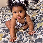 Akyli joined the competition — help win amazing prizes! baby, child, curly_hair, headband, leopard_print, bedspread, crawling, indoor, cute, playful, person, infant, fashion, pattern, smiling, skin, hand, footwear, bed, pillow