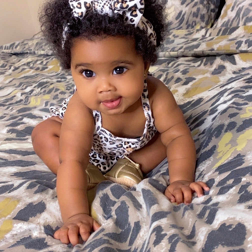 Akyli joined the competition — help win amazing prizes! baby, bed, bedspread, child, crawling, curly_hair, cute, fashion, footwear, hand, headband, indoor, infant, leopard_print, pattern, person, pillow, playful, skin, smiling