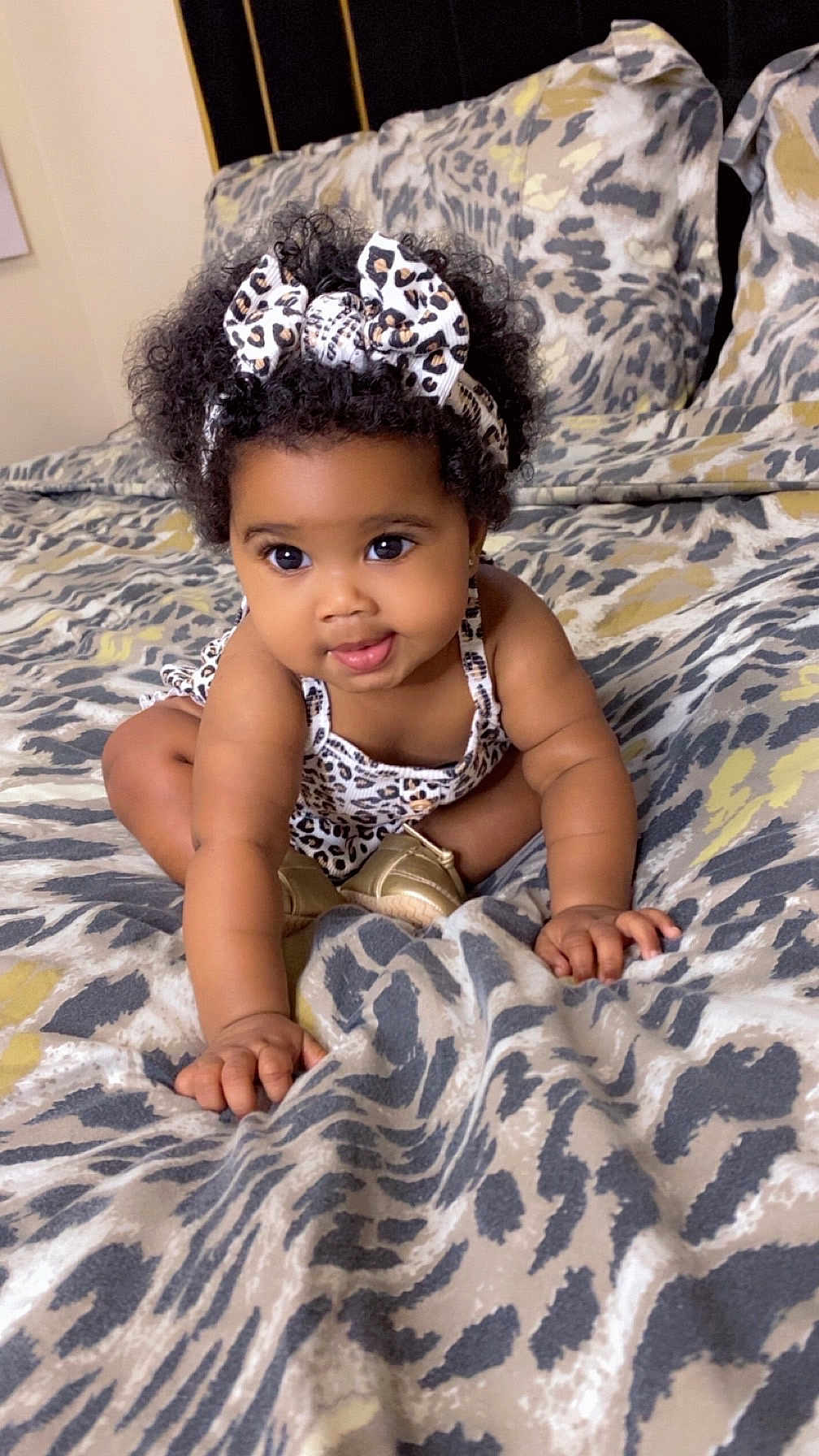 Akyli joined the competition — help win amazing prizes! baby, child, curly_hair, headband, leopard_print, bedspread, crawling, indoor, cute, playful, person, infant, fashion, pattern, smiling, skin, hand, footwear, bed, pillow