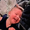 Amelia is registered to the contest to win money with this photo: toddler, child, smile, laughing, happy, blanket, fabric, cozy, face, head, earring, indoor, soft, clothing, person, closeup, cute, joy, baby, warmth