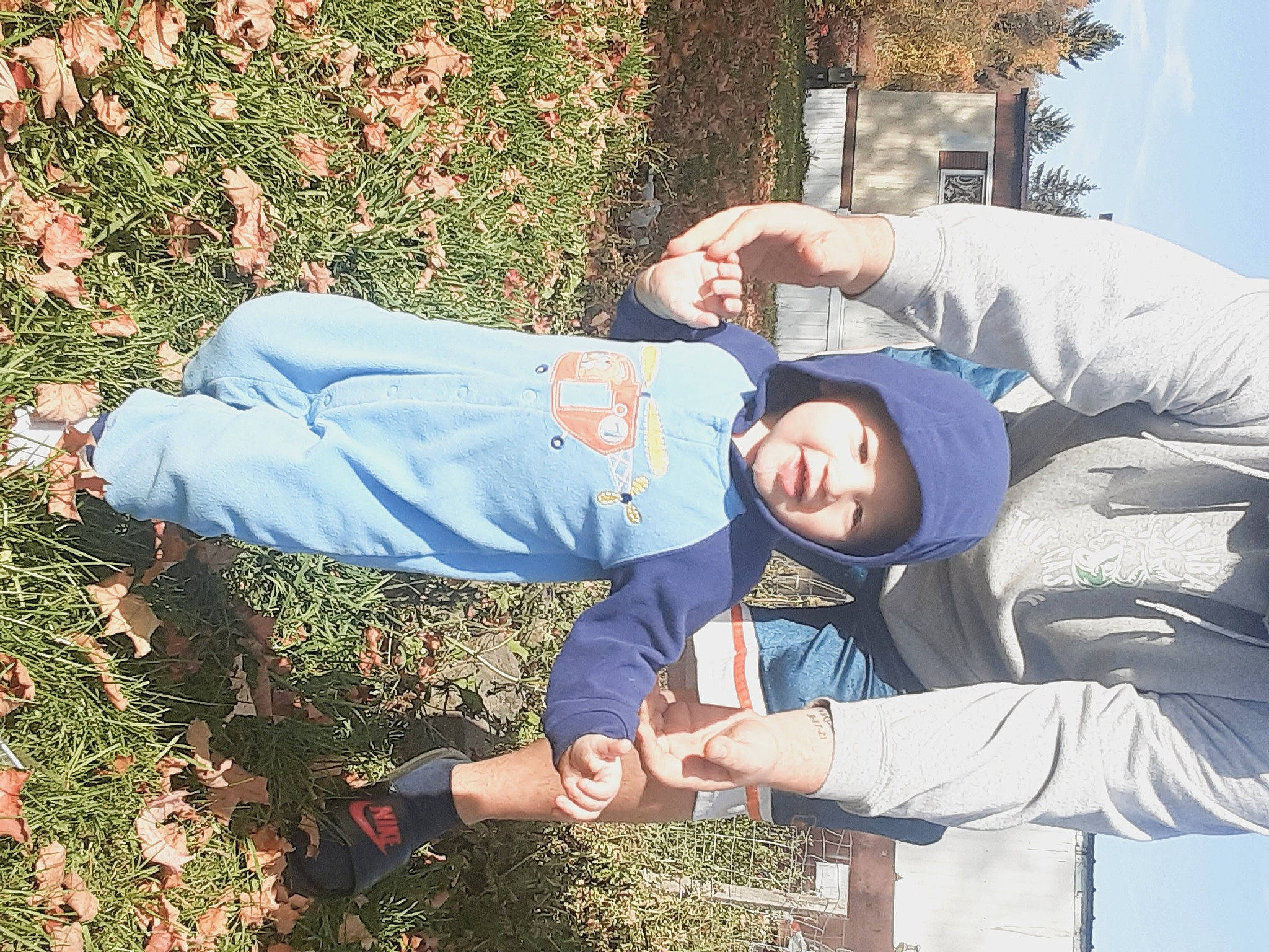 Nikolai is registered to the contest to win money with this photo: child, electric_blue, fun, gesture, grass, groundcover, happy, headwear, leisure, people_in_nature, person, photograph, plant, sitting, sky, smile, soil, tree, windbreaker